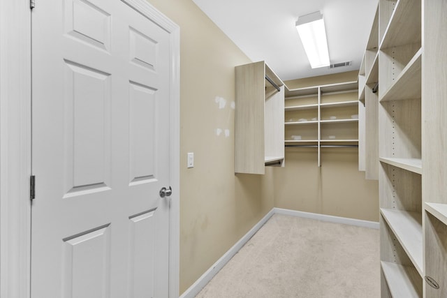 walk in closet with carpet
