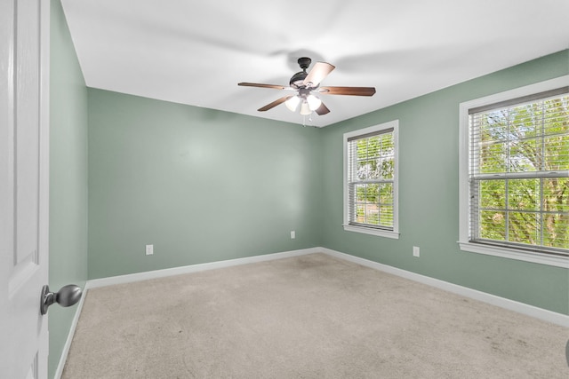 empty room with carpet floors, baseboards, and ceiling fan