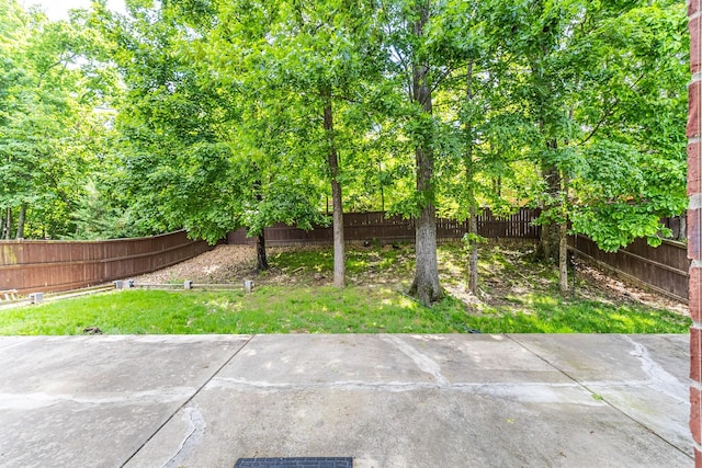 fenced backyard with a patio area