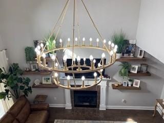 living room featuring baseboards, wood finished floors, and a chandelier