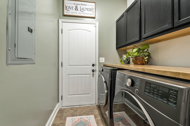 clothes washing area featuring washing machine and dryer, electric panel, baseboards, and cabinet space