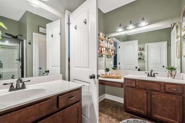 full bath with two vanities, tile patterned floors, a sink, and a shower stall