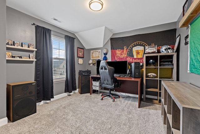 office space with vaulted ceiling, carpet, visible vents, and baseboards