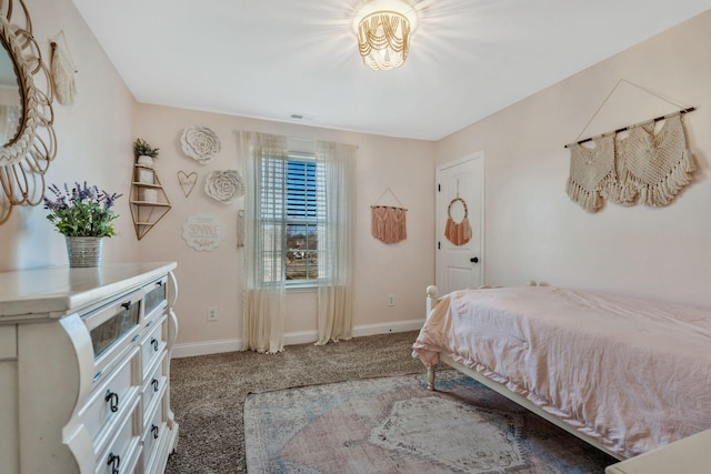 bedroom featuring baseboards, visible vents, and carpet