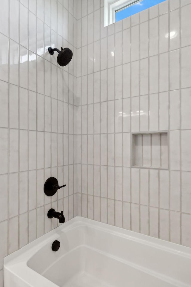 bathroom with tile walls and bathing tub / shower combination