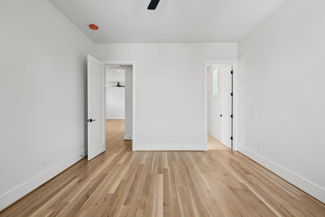 unfurnished bedroom featuring ceiling fan, baseboards, and wood finished floors