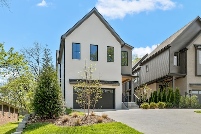 modern home with concrete driveway, stucco siding, and a garage