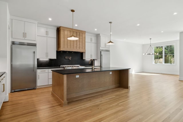 kitchen featuring backsplash, stainless steel built in refrigerator, dark countertops, and recessed lighting