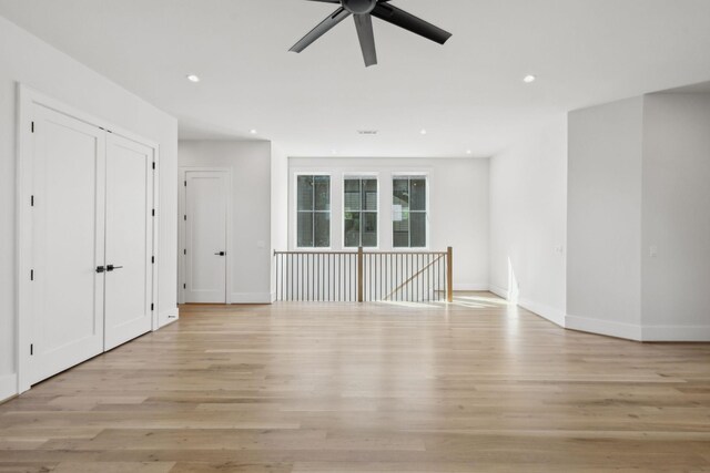 unfurnished living room with recessed lighting, light wood-type flooring, baseboards, and ceiling fan
