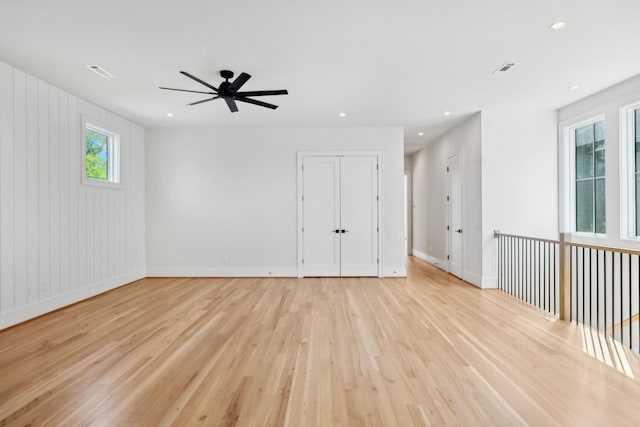 spare room with recessed lighting, light wood-style floors, a ceiling fan, and baseboards