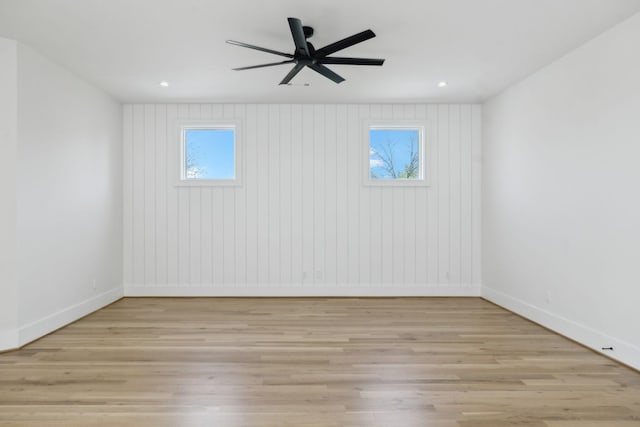 spare room featuring baseboards, recessed lighting, light wood-style floors, and ceiling fan