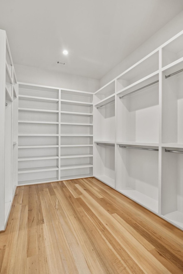 spacious closet featuring wood finished floors and visible vents