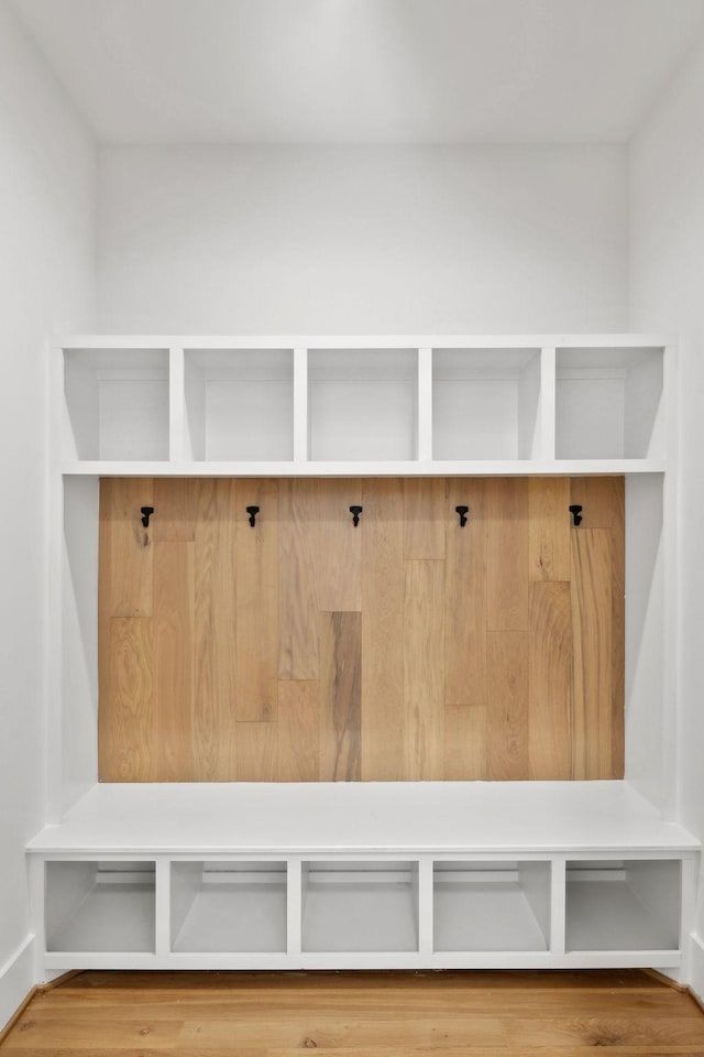 mudroom featuring wood finished floors and baseboards