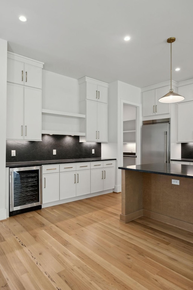 kitchen with beverage cooler, open shelves, dark countertops, backsplash, and stainless steel built in fridge
