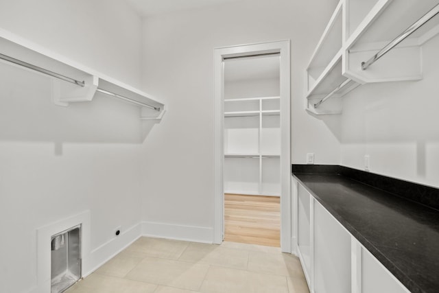 walk in closet featuring light tile patterned flooring