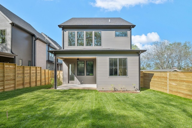 rear view of property featuring a fenced backyard, a patio, and a lawn