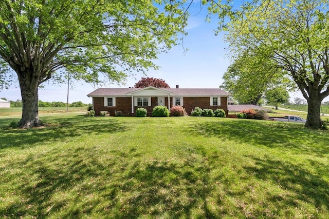 ranch-style home featuring brick siding and a front yard