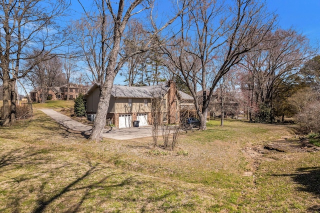 8309 Alamo Rd, Brentwood, TN 37027 - view of yard with an attached garage and driveway