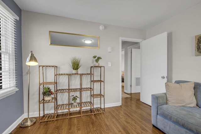 living area with wood finished floors and baseboards