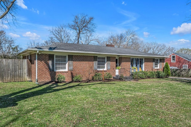 ranch-style home with brick siding, a front lawn, fence, and a chimney