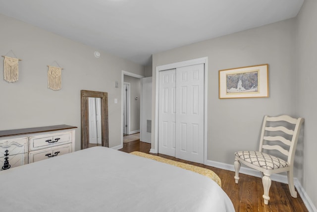 bedroom featuring dark wood finished floors, a closet, and baseboards