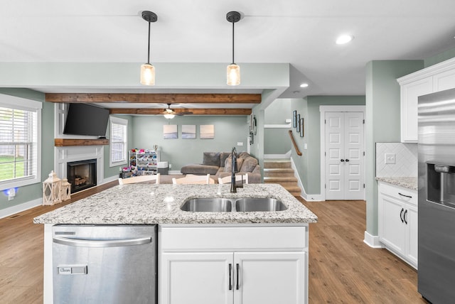 237 Wade Hampton Ln, Clarksville, TN 37040 - kitchen with baseboards, a sink, appliances with stainless steel finishes, and open floor plan
