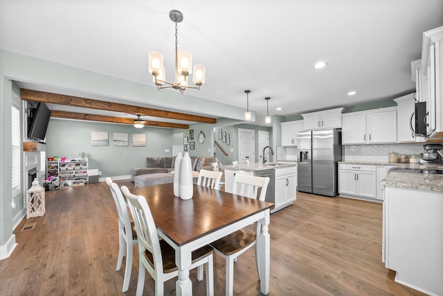 237 Wade Hampton Ln, Clarksville, TN 37040 - dining area featuring an inviting chandelier, beam ceiling, light wood-style floors, recessed lighting, and baseboards