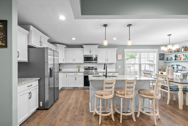 237 Wade Hampton Ln, Clarksville, TN 37040 - kitchen with a chandelier, white cabinets, tasteful backsplash, a sink, and stainless steel appliances