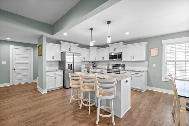 237 Wade Hampton Ln, Clarksville, TN 37040 - kitchen featuring baseboards, white cabinets, tasteful backsplash, a sink, and stainless steel appliances