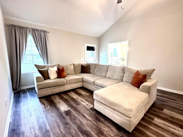 living room featuring a ceiling fan, baseboards, high vaulted ceiling, and dark wood-type flooring