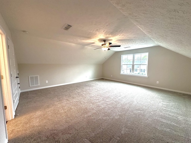bonus room featuring carpet floors, lofted ceiling, and visible vents