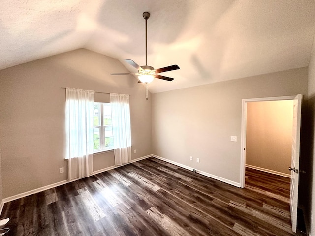 unfurnished bedroom featuring a textured ceiling, ceiling fan, baseboards, dark wood finished floors, and lofted ceiling