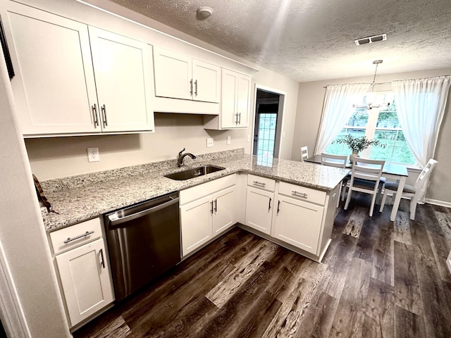 kitchen featuring a sink, dishwasher, visible vents, white cabinetry, and dark wood-style floors