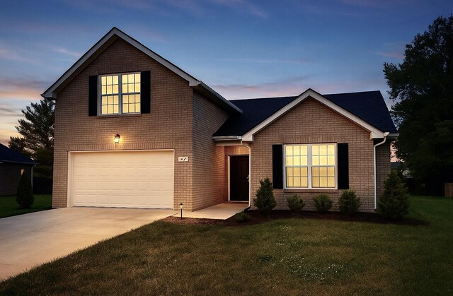view of front of home with a garage, driveway, a front lawn, and brick siding