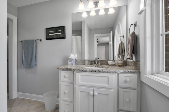 full bath with vanity, ceiling fan, tile patterned floors, and baseboards