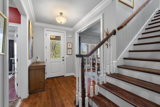 entrance foyer featuring stairway, ornamental molding, dark wood-type flooring, and baseboards