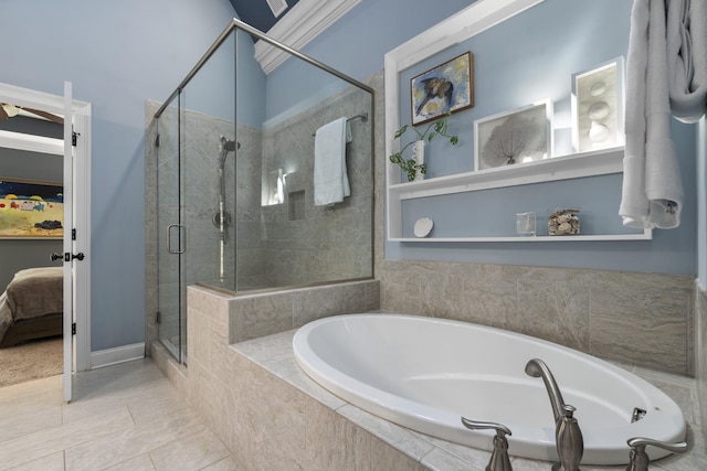 ensuite bathroom featuring a garden tub, ensuite bathroom, and a stall shower