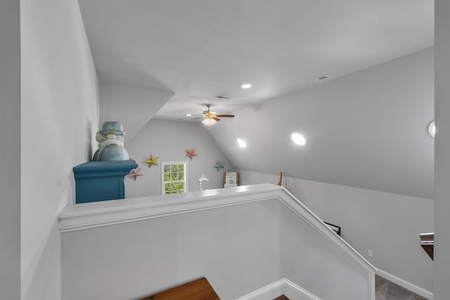 staircase featuring lofted ceiling, ceiling fan, and recessed lighting