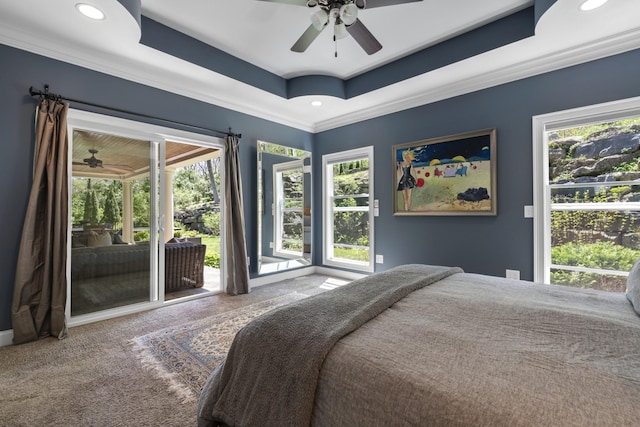 bedroom featuring recessed lighting, a tray ceiling, access to exterior, carpet, and ornamental molding