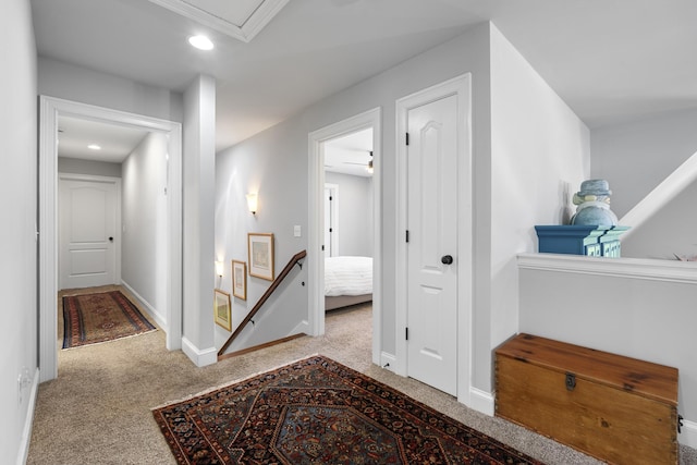 corridor with recessed lighting, an upstairs landing, carpet flooring, and baseboards