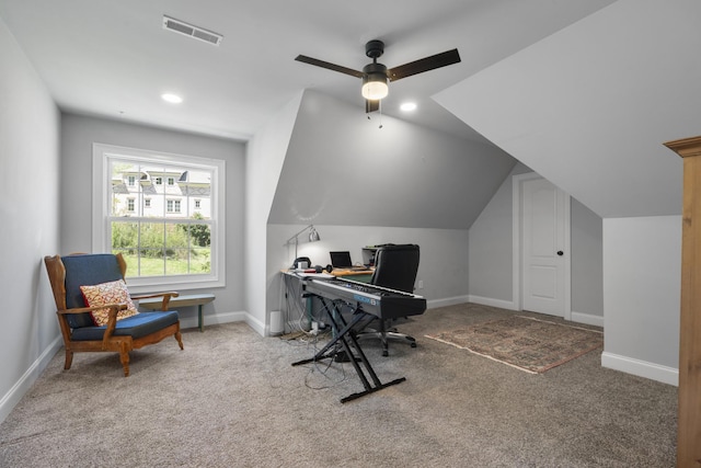 office space featuring lofted ceiling, visible vents, ceiling fan, and carpet floors