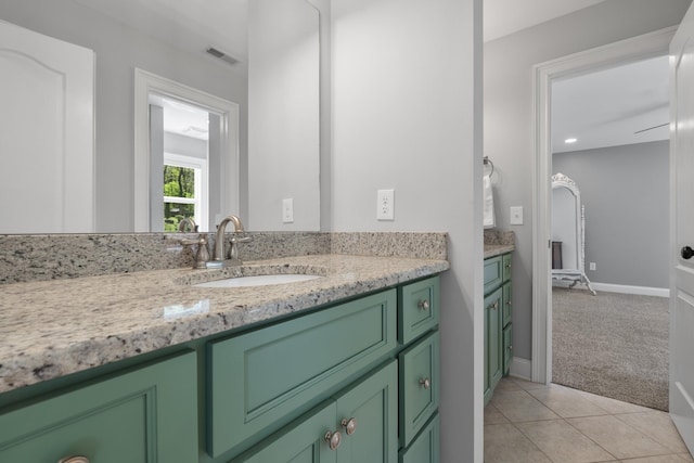 bathroom featuring tile patterned flooring, visible vents, vanity, and baseboards