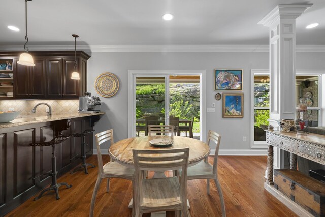 dining room featuring recessed lighting, ornamental molding, dark wood-style floors, and decorative columns