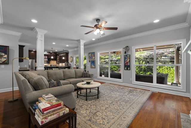 living room with baseboards, ornate columns, a ceiling fan, and dark wood-type flooring