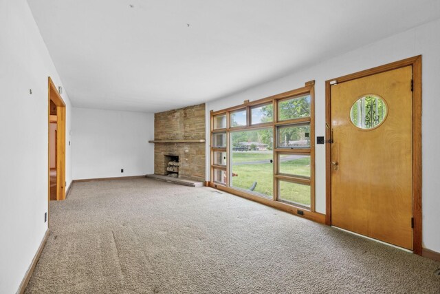 909 Hillsboro Rd, Franklin, TN 37064 - unfurnished living room featuring baseboards, a large fireplace, and carpet