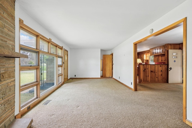 909 Hillsboro Rd, Franklin, TN 37064 - unfurnished living room featuring baseboards, visible vents, a wealth of natural light, and light carpet