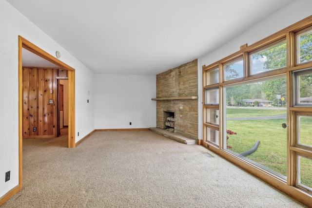 909 Hillsboro Rd, Franklin, TN 37064 - unfurnished living room featuring visible vents, baseboards, a stone fireplace, and carpet flooring
