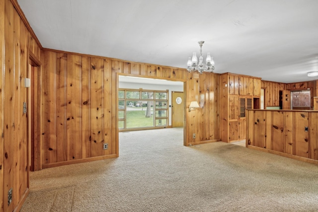 909 Hillsboro Rd, Franklin, TN 37064 - unfurnished living room with carpet flooring, wood walls, baseboards, and a notable chandelier