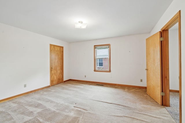 909 Hillsboro Rd, Franklin, TN 37064 - unfurnished bedroom with visible vents, baseboards, and light carpet