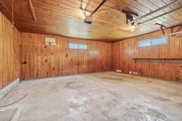 909 Hillsboro Rd, Franklin, TN 37064 - garage featuring wood ceiling, a garage door opener, and wood walls